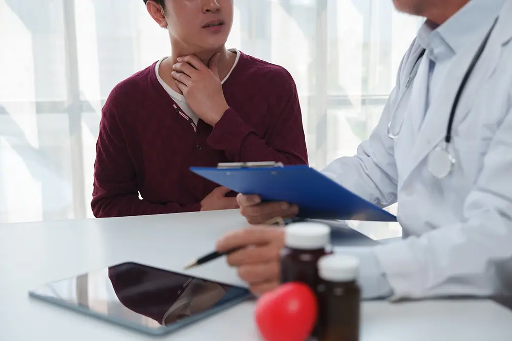 A patient experiencing chronic laryngopharyngeal reflux consulting an ENT specialist