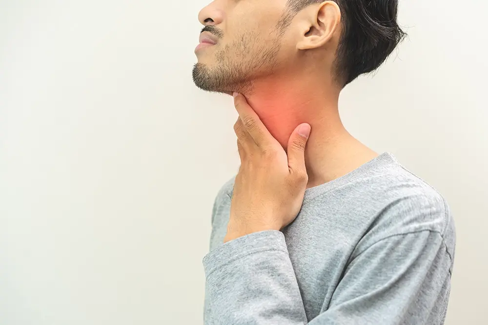 A man experiencing persistent throat symptoms