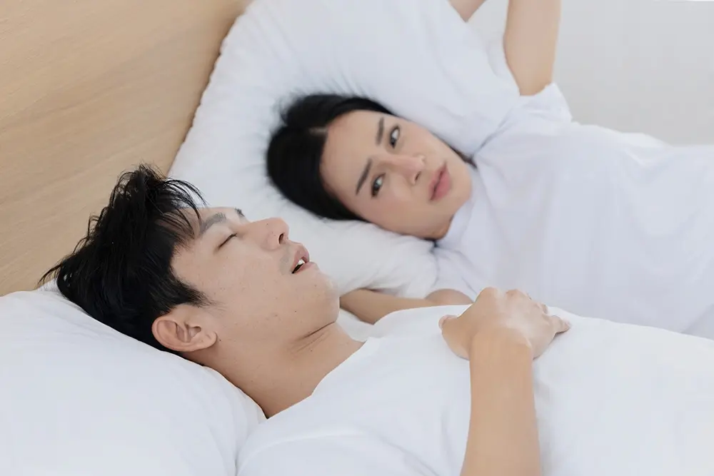 A man snoring while sleeping due to chronic congestion