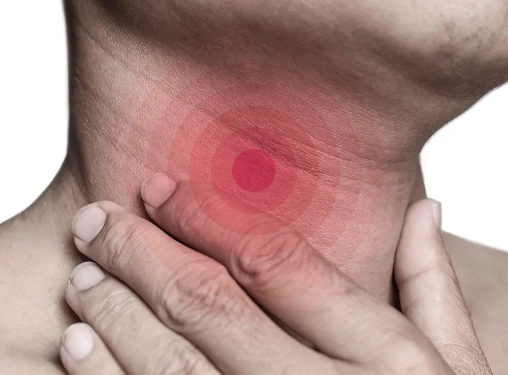 Close-up of a man experiencing strained vocal cords as a possible sign of a voice disorder