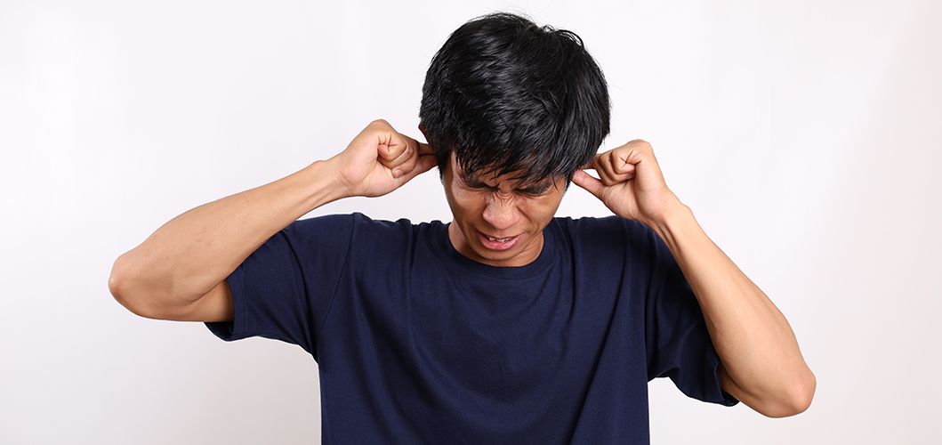 A young man suffering from Eustachian tube dysfunction