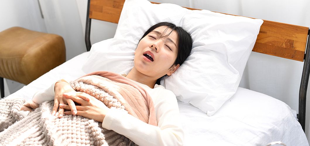 A woman snoring while sleeping