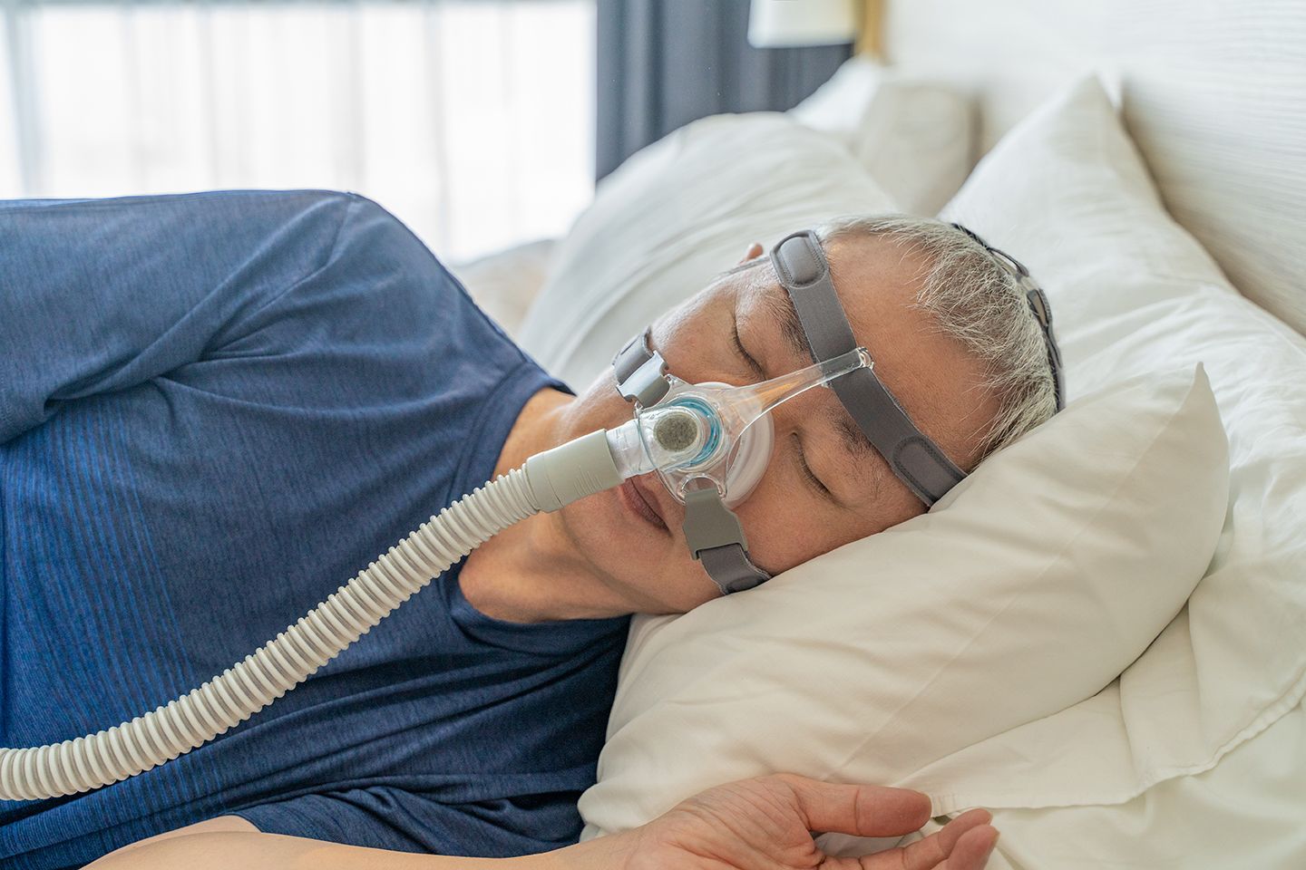 A man using a CPAP machine while sleeping