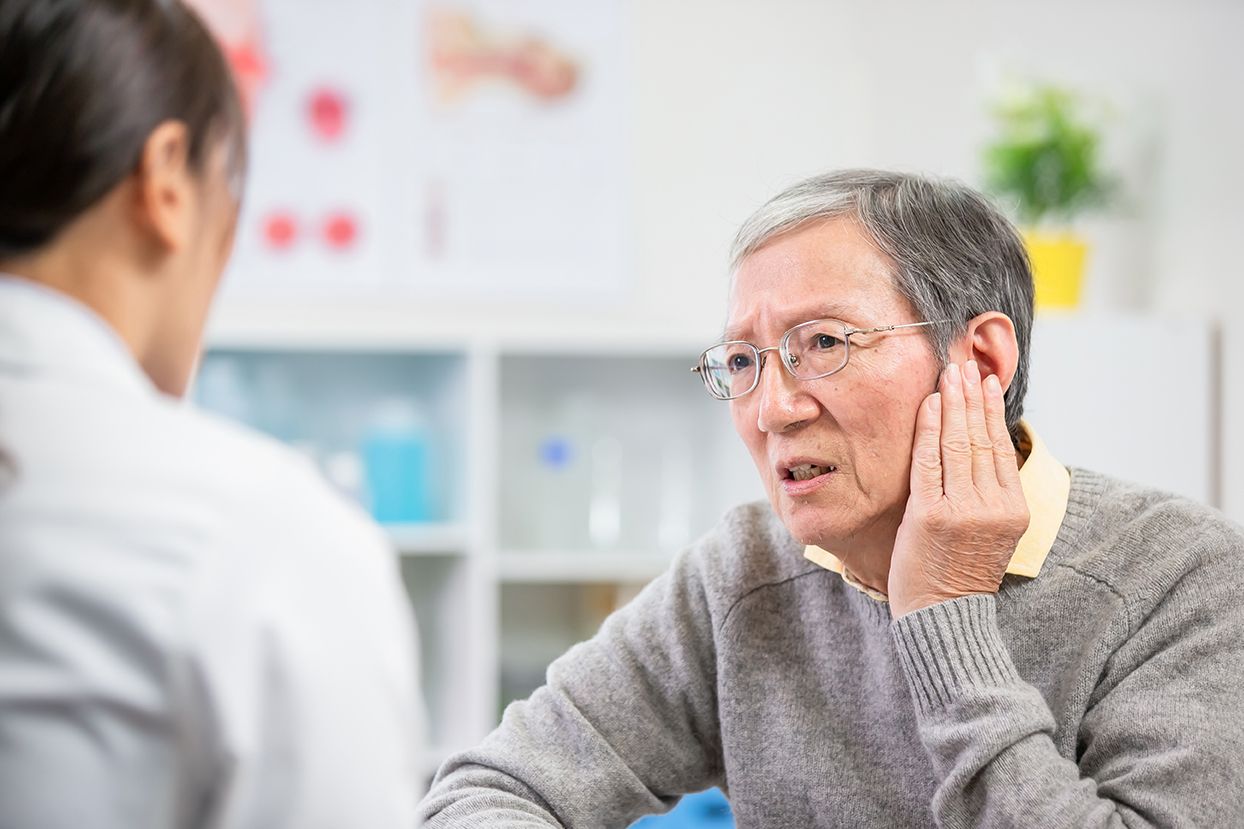 An elderly man getting treated for his tinnitus